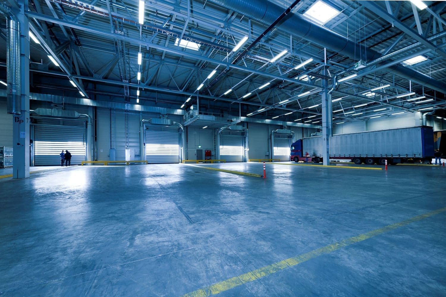 A large, level finished industrial warehouse concrete floor.